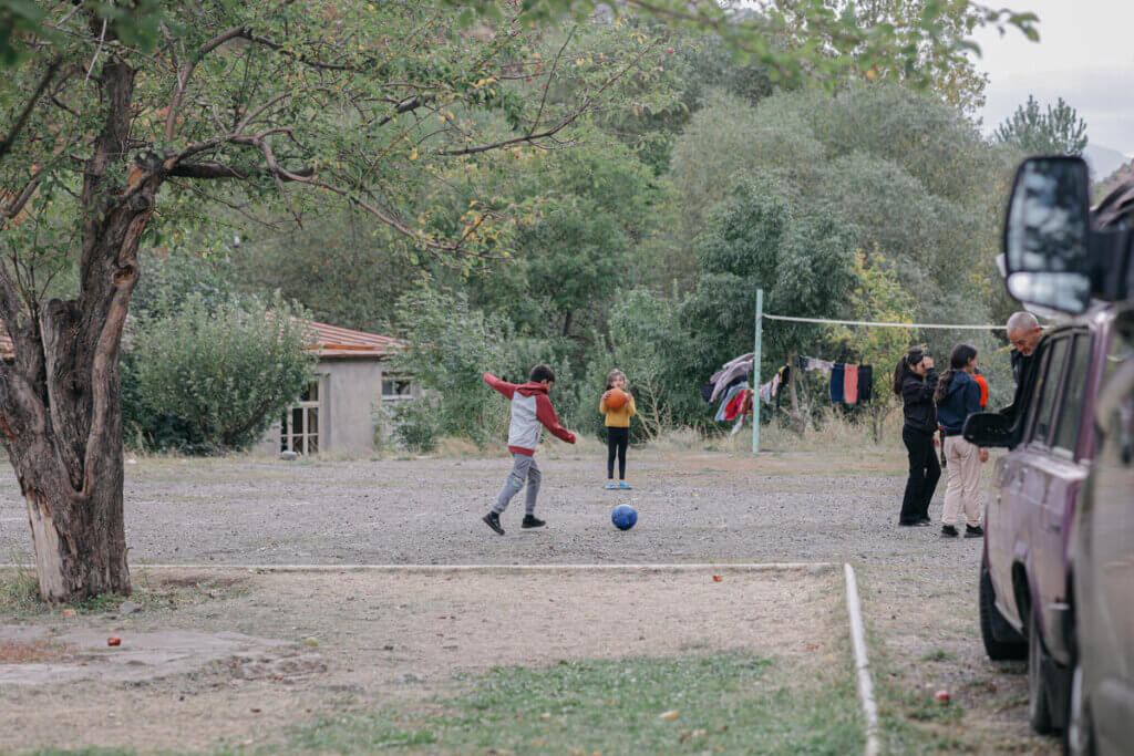 Children play outside at a site for displaced people in Armenia. 