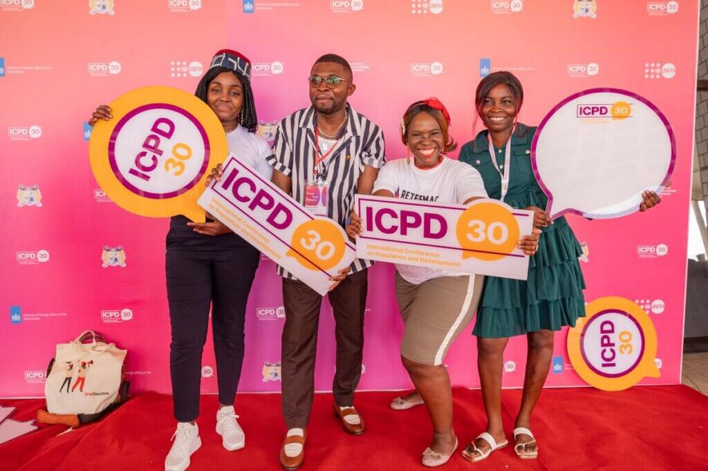 Participants at ICPD30's Global Youth Dialogue hold signs.