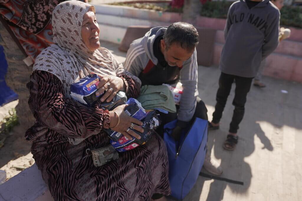 Woman receives menstrual products from UNFPA via a Dignity Kit