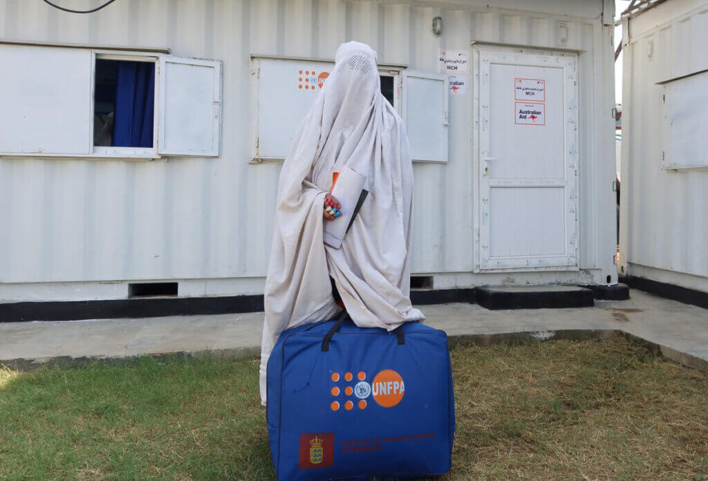 A woman holds a UNFPA kit after visiting an emergency maternity clinic.